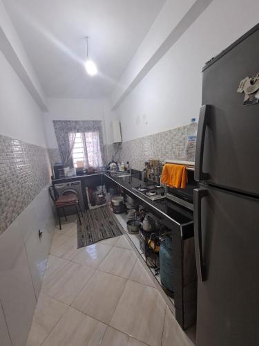 a kitchen with a stove and a refrigerator at Medhouse in Mohammedia