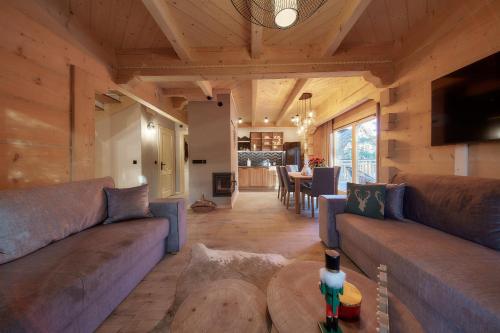 a living room with a couch and a table at Tatra Wood House Boutique in Zakopane