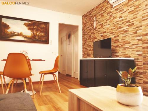 a living room with two chairs and a television at Blue Sky Berlin - Passeig Jaume I in Salou