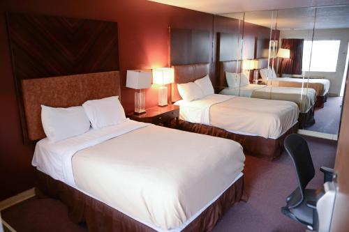 a hotel room with two beds and two lamps at Relax Inn in Collinsville