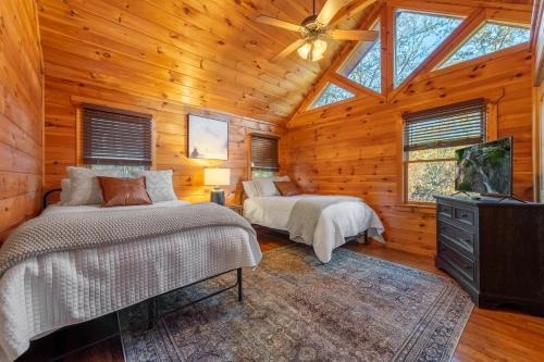 a bedroom with two beds and a ceiling fan at Beautiful 4BR Mountain View Cabin A Retreat for Everyone in Murphy