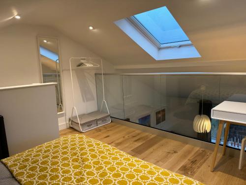 a bedroom with a bed and a skylight at The Lookout in Wedmore