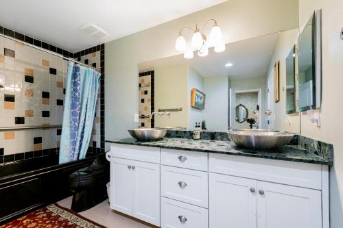 two sinks in a bathroom with two mirrors at Dream Villa in Las Vegas