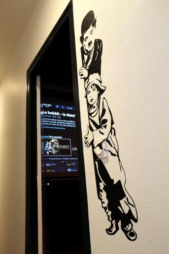 a drawing of two men on a wall at LE 7E ART Salle de cinéma privée centre Agen in Agen