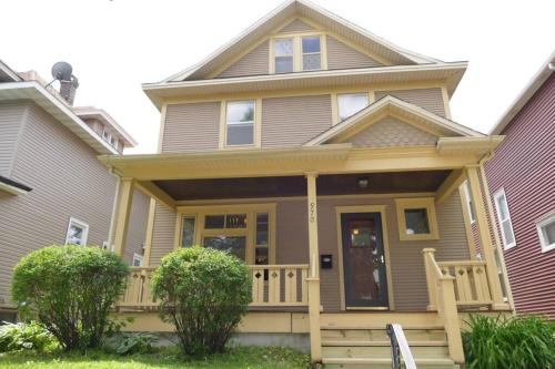 a house with a front porch with a deck at St Paul - Lower Level Apartment. Near downtown & Allianz stadium. in Saint Paul