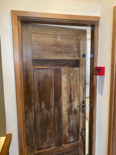 a wooden door in a room at Hostel 364 Santos Dorm Privativo com Alexa in Santos