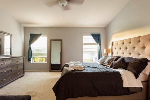 a bedroom with a large bed and a large window at Cheerful 4 Bedroom Salt Water Heated Pool & Spa in Riverview