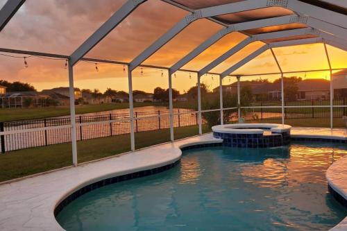 a swimming pool with a canopy over it at Cheerful 4 Bedroom Salt Water Heated Pool & Spa in Riverview