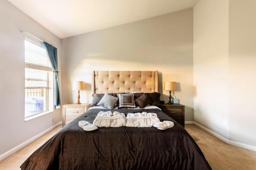 a bedroom with a bed with two towels on it at Cheerful 4 Bedroom Salt Water Heated Pool & Spa in Riverview