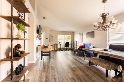 a living room with a table and a dining room at Cheerful 4 Bedroom Salt Water Heated Pool & Spa in Riverview