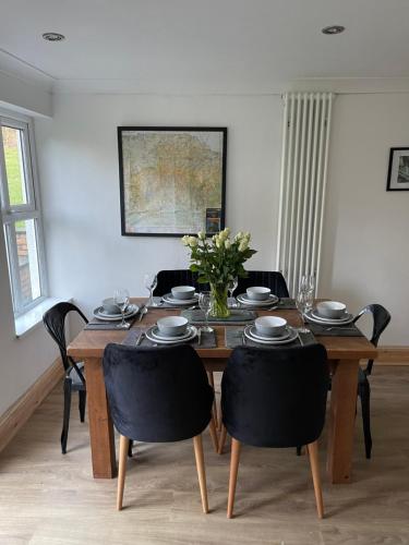 a dining room with a wooden table and chairs at Upsall Warren Cottage in Middlesbrough