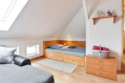 a bedroom with a bed in the attic at APARTMÁN U MAXÍKŮ in Černý Dŭl