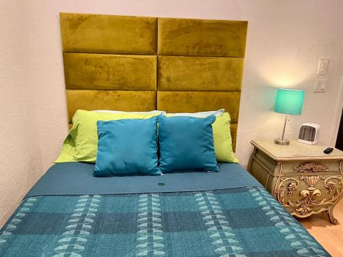 a bedroom with a bed with blue and yellow pillows at The Scandinavian Contemporary Blauw in Lake Alfred