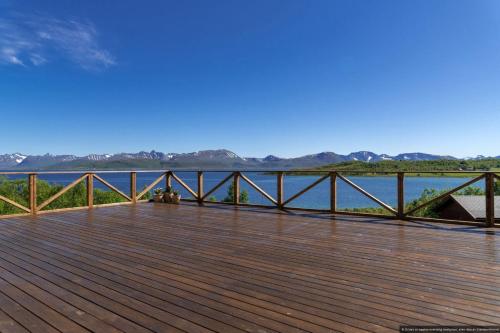 a wooden deck with a view of the water at Centrally Located Cabin by the Sea - Sortland in Sortland