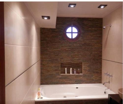 a bath tub in a bathroom with a window at Miramar in Miramar