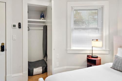 a white bedroom with a bed and a window at Charlesgate Suites in Boston