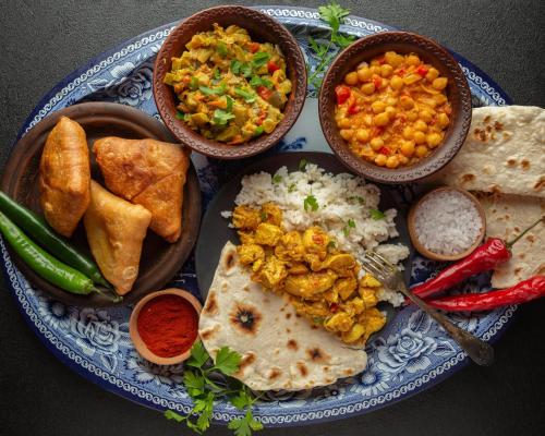 a blue plate of food with different types of food at Hotel SolStay Inn Residency in Thane