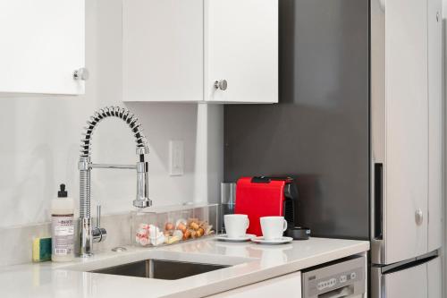 a kitchen counter with a sink and a faucet at Charlesgate Suites in Boston