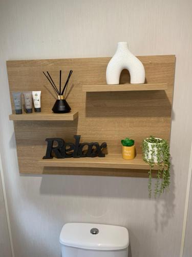 a wooden shelf above a toilet in a bathroom at 4 Devon Country, Bideford Bay Holiday Park in Bucks Mills