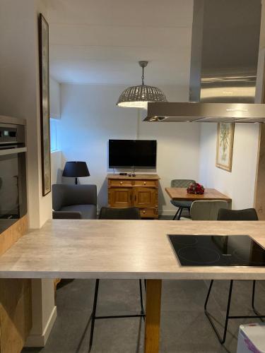 a kitchen and living room with a dining table at De Schuure 't Voorde in Winterswijk in Winterswijk