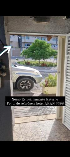 a car parked in a garage with a door open at Pousada Recanto da Família in Natal