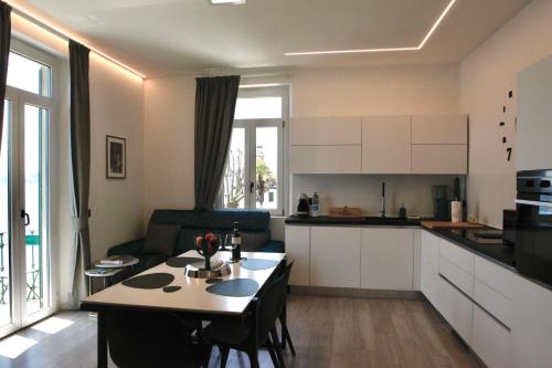 a kitchen and a living room with a table in a room at Belvedere 229 Lakeview Apartment in Ghiffa