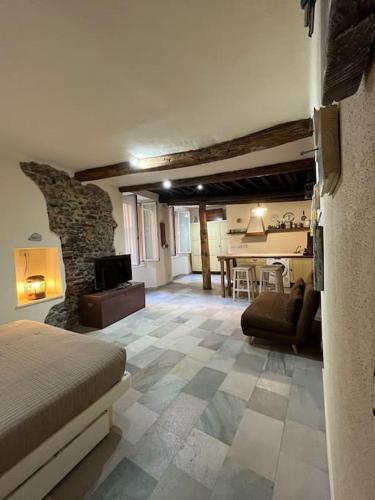 a bedroom with a living room with a stone fireplace at Iris 3: Un Fiore a Camogli in Camogli