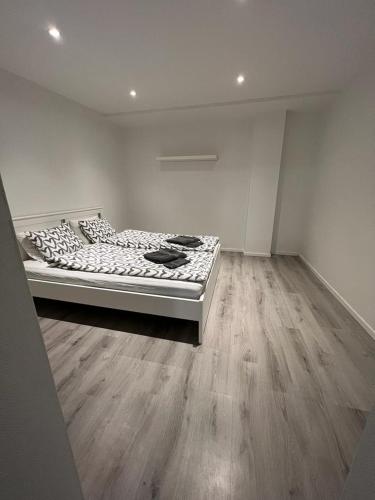 a bed in a room with a wooden floor at New Two Bedroom Apartment Close To Beach in Abbekås