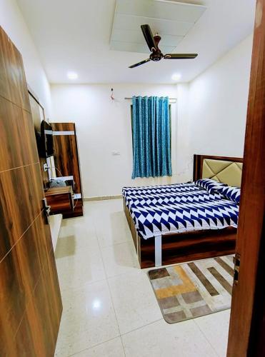 a bedroom with a blue and white bed in a room at Hotel dream taj family rooms 200mtr from taj mahal in Agra