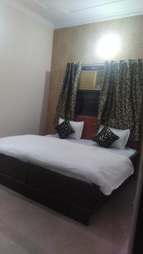 a bedroom with a bed with two pillows on it at Hotel dream taj family rooms 200mtr from taj mahal in Agra