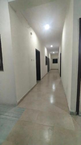 an empty hallway with white walls and a long corridor at Hotel dream taj family rooms 200mtr from taj mahal in Agra