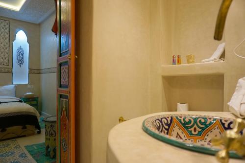 a bathroom with a sink and a mirror at Flowers riad in Marrakech