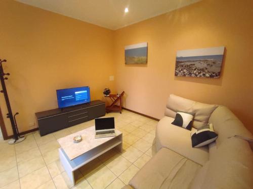 a living room with a couch and a tv at Casa Zia Luisa in Lecco