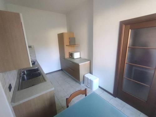 a small kitchen with a sink and a refrigerator at Casa Zia Luisa in Lecco