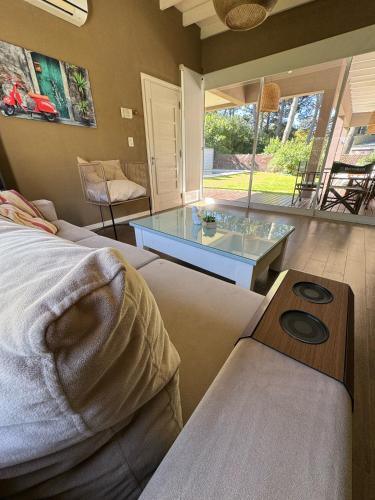 a bedroom with a bed and a glass table at Musas con Pileta NO ACEPTO GRUPO DE JOVENES in Pinamar