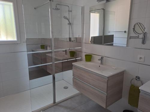 a white bathroom with a sink and a shower at Ginatella - 3 chambres in Deaux