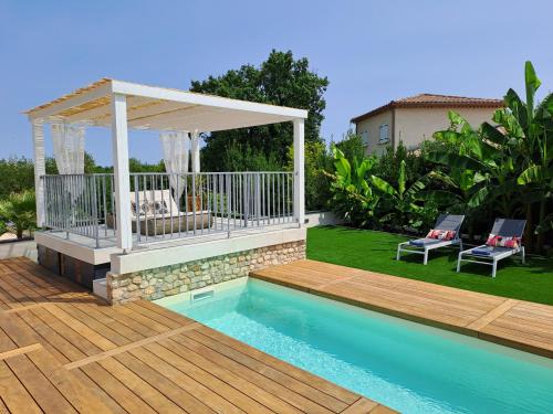 a pool with a gazebo next to a house at Ginatella - 3 chambres in Deaux