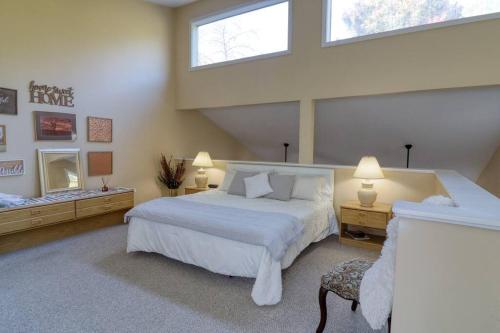 a bedroom with a large white bed and two windows at Bryce Chalet Retreat A Mountain Getaway in Basye