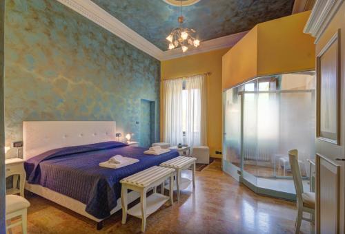 a bedroom with a bed and a table and chairs at Raffaello Residence in Sassoferrato