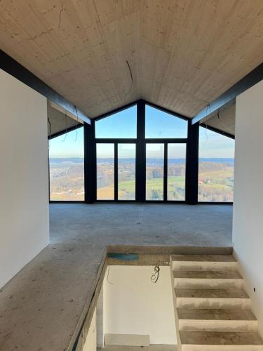 an empty room with large windows in a building at Bretterbude Steiermark in Übersbach