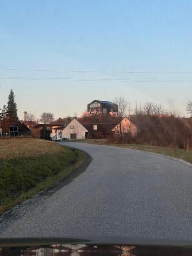 an empty road with a house in the distance at Bretterbude Steiermark in Übersbach