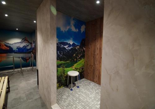 a room with a mural of mountains on the wall at Alpenstadel_B18 in Oberstdorf
