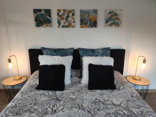 a bedroom with a bed with pillows and two lamps at La Tourelle Suite Cosy entre vignoble aixois et Luberon in Le Puy-Sainte-Réparade
