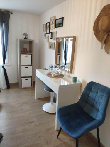 a white desk with a blue chair and a mirror at La Tourelle Suite Cosy entre vignoble aixois et Luberon in Le Puy-Sainte-Réparade