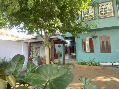 a house with a tree in front of it at Solar das Pétalas Guest House in Florianópolis