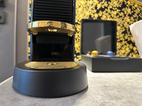 a black and gold object on a table at Villa Mala Praha Experience in the Center of Žilina in Žilina