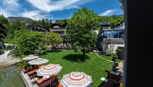 an aerial view of a resort with umbrellas on a lawn at Cortisen am See - Adults only in St. Wolfgang
