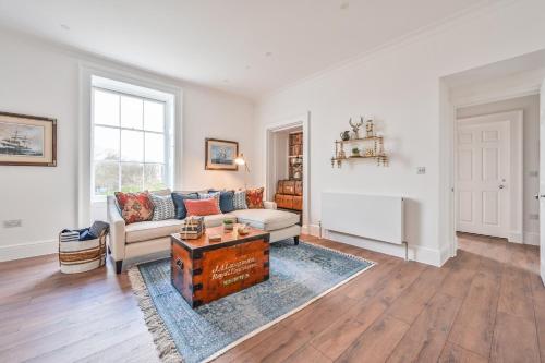 a living room with a couch and a table at 9 Admiralty House Stunning Luxury Apartment with free parking in Plymouth