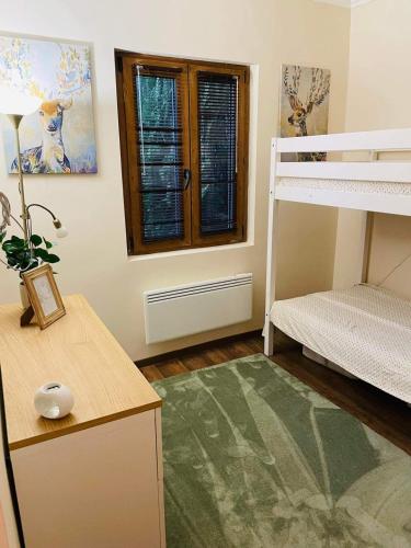a bedroom with a bunk bed and a desk and a bunk bed at Maradj Még Vendégház in Balatonakarattya