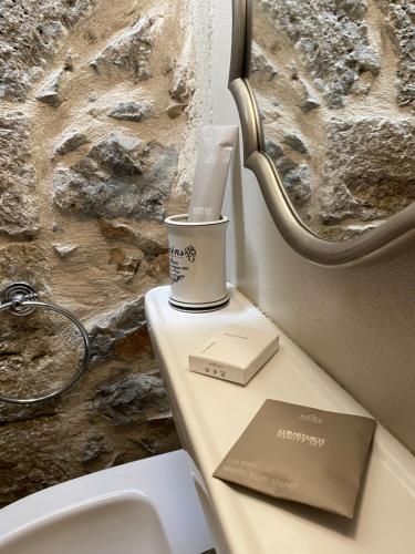 a table with a cup on top of a toilet at Ypsus House Stemnitsa in Stemnitsa